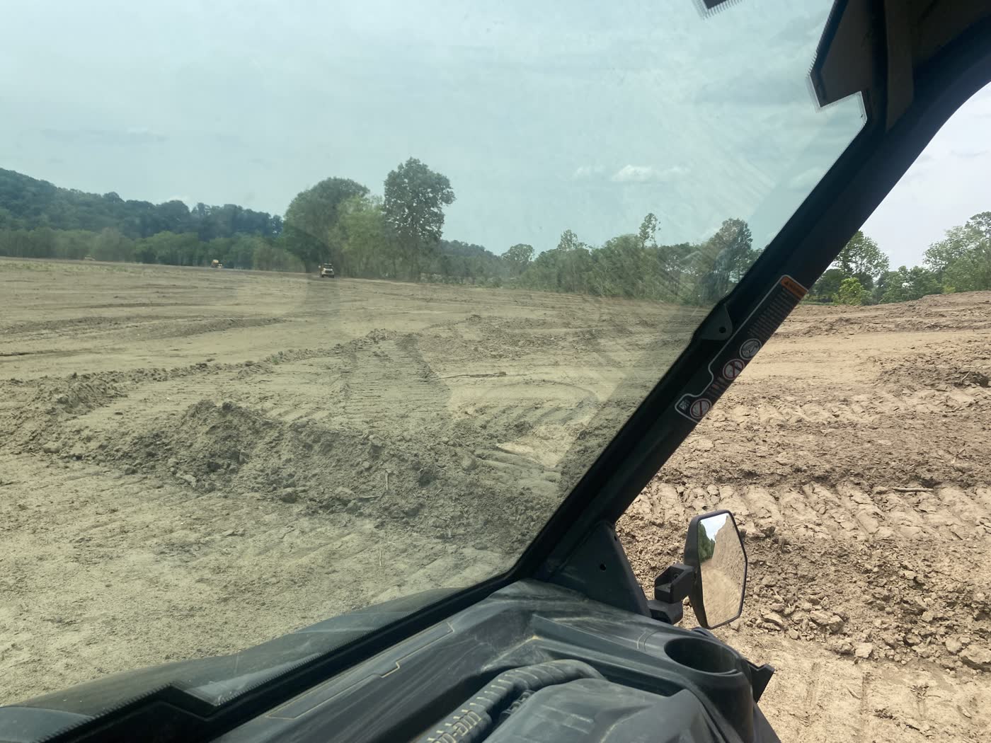 Flood-scoured ground on the property, cleared and graded